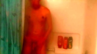 Athletic gay boy masturbates in the shower.