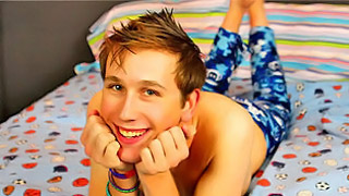 Lovely slender twink smiles as he poses in the bed