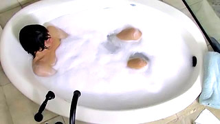 Gorgeous dark haired twink plays with foam in the tub